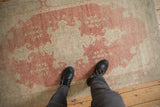 Distressed Oushak rug pile with mostly even wear showing the knot heads and foundation.