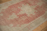 Abrashed field of the distressed Oushak rug showing the low pile and mostly even wear.