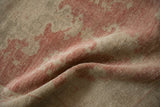 Close-up of the vintage Oushak rug's low pile showing wear across the knot heads.