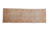 Vintage distressed Oushak runner with elongated hexagonal medallions in pale tangerine and slate blue.