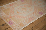 Angled view of the distressed Oushak runner's texture, showing even wear to the knot heads.