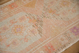Visible hand-worked repairs and distressed texture on the vintage Turkish Oushak rug runner.