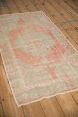 Angled view of a distressed Oushak runner showing its soft, low-pile texture.