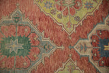 Geometric motifs in ruby red, lime green, and oxidized silver on a distressed pile.