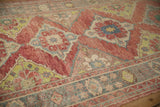 Distressed texture and visible knot heads on ruby red, green, and blue geometric medallions.