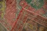 Woven back and textured ruby red pile of a distressed vintage Oushak rug runner.