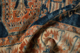 Detail of the soft, distressed pile and serrated patterns in indigo and terra cotta on an Oushak rug.