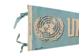 Handwritten dates from 1968 and 1971 beside the UN logo on a vintage blue felt pennant.