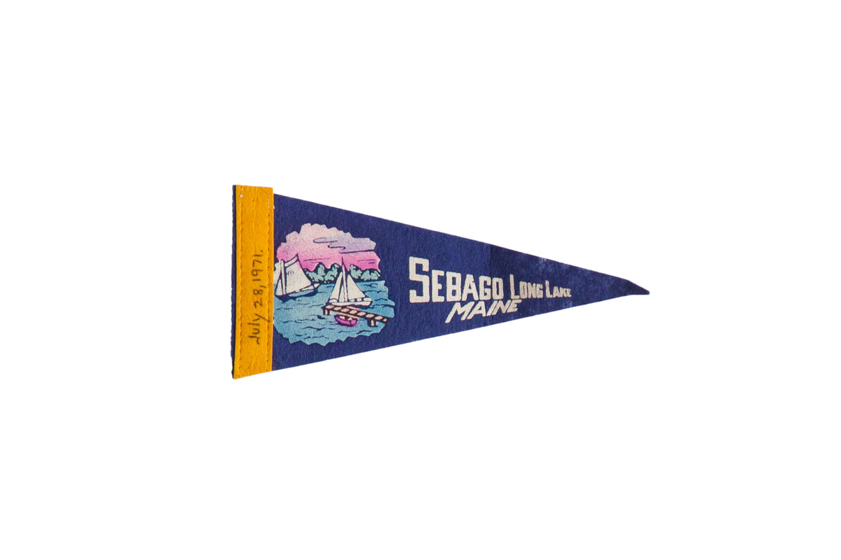 Vintage Sebago Long Lake felt pennant in blue with a sailboat graphic and yellow spine.
