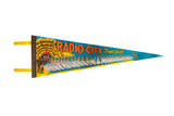 Vintage Radio City Music Hall felt pennant featuring a line of ballerinas on a vibrant blue background.