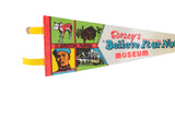 Handwritten 1975 date and illustrated panels on a vintage Ripley's Believe It or Not pennant.
