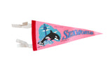 Vintage pink Seaworld felt pennant with a graphic of a jumping killer whale and Sky Tower.