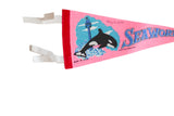 Printed killer whale graphic and handwritten 1975 date on the vintage pink Seaworld pennant.