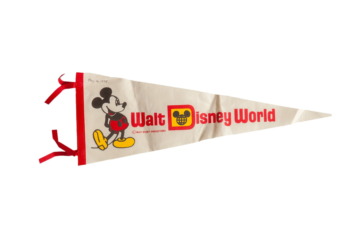 A classic 1970s Walt Disney World felt pennant in ivory, with red lettering and a Mickey Mouse graphic.