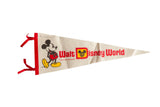 A classic 1970s Walt Disney World felt pennant in ivory, with red lettering and a Mickey Mouse graphic.