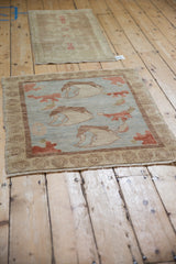 Modern Oushak rug corner shows unique spiral border and powder blue field with cinnabar flower.