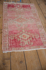 Intact side cord selvage and abrashed pink, beige tones on distressed Kars rug corner.