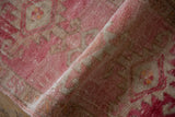 Distressed pile texture with abrashed bubble gum pink, raspberry red, and beige tones.