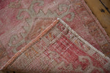 Vintage distressed Kars rug showing faded pink pile and hand-knotted construction.