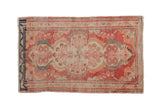 Distressed vintage Dargezine rug with faded cinnabar red and ivory floral medallion, teal accents. 2'4