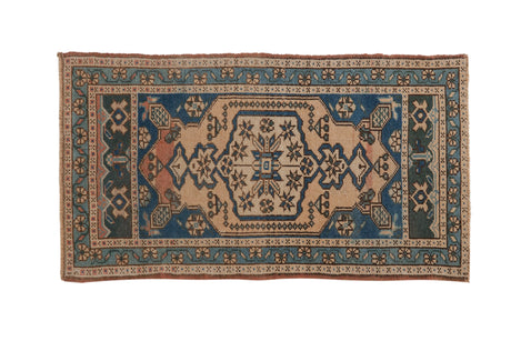 Distressed Oushak rug with central floral medallion in sandalwood, cobalt blue, and teal, 2x3.7.