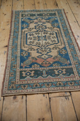 Distressed lower border and field details of a vintage Oushak rug in dusty teal and ivory.