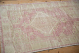 Distressed vintage Oushak rug pile with soft dusty pink and ivory abrashes.