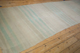 Textural view of the distressed vintage Turkish Kilim runner's soft beige and mint green bands.