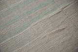 Distressed flatweave texture of vintage Turkish Kilim rug with beige and soft mint bands.