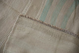 Hand-woven construction detail of the vintage Turkish Kilim runner showing subtle mint green stripe.