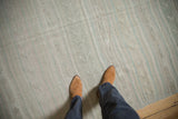 Raised woven elements and angular finned motifs on a distressed vintage Turkish Kilim runner.
