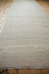 Distressed vintage Turkish Kilim with textured raised geometric patterns in neutral tones.