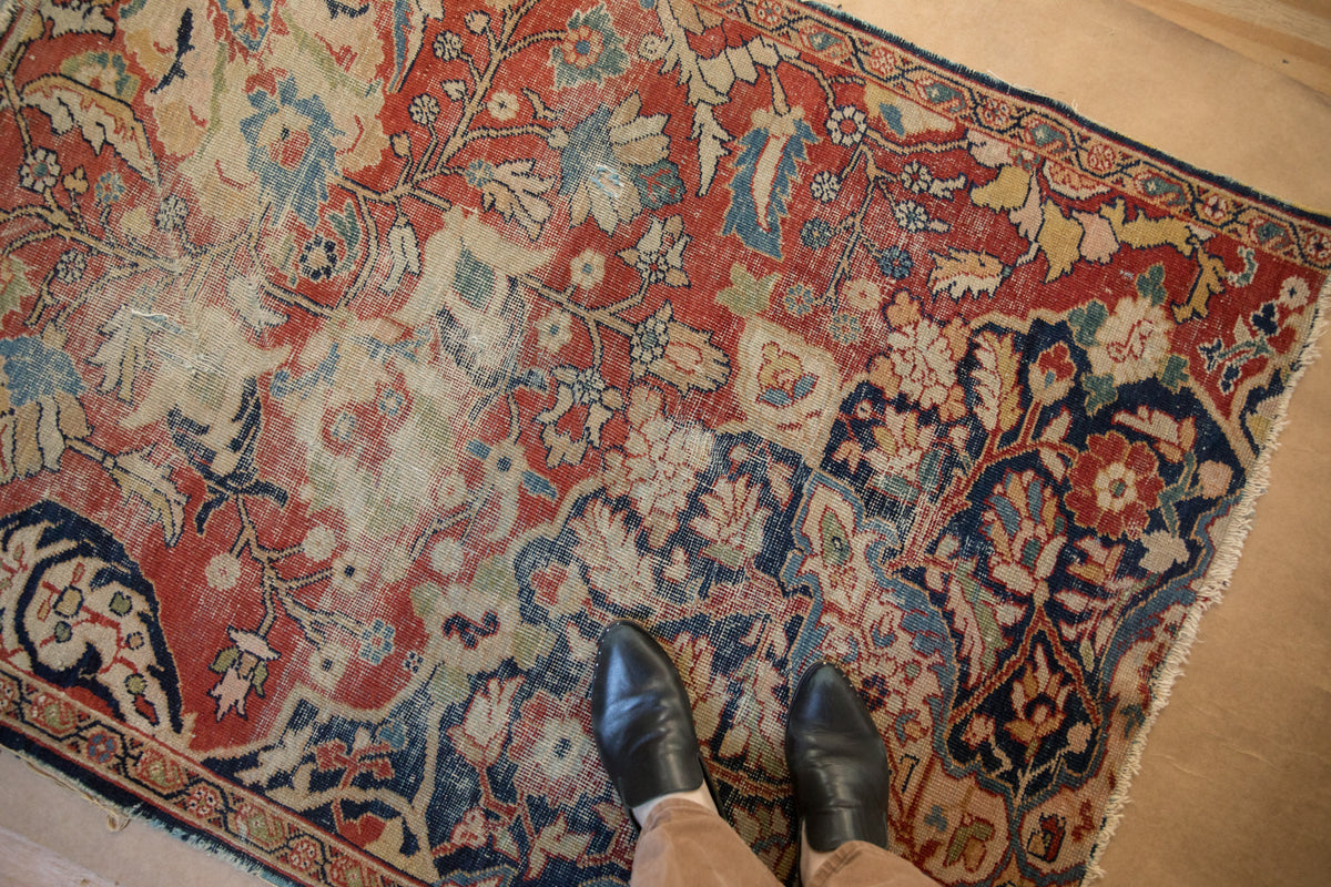 Antique Sultanabad rug's intricate floral arabesque in cherry red, navy, ivory, softened tones.