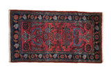 Vintage Persian Mehreban rug with raspberry red field, scrolling tendrils, blossoms, and navy Herati border.