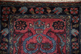 Mehreban rug pile shows raspberry field, expressive leaves, and navy Herati border.