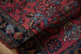 Thick, raspberry red pile with navy blue floral motifs on a Vintage Mehreban rug.