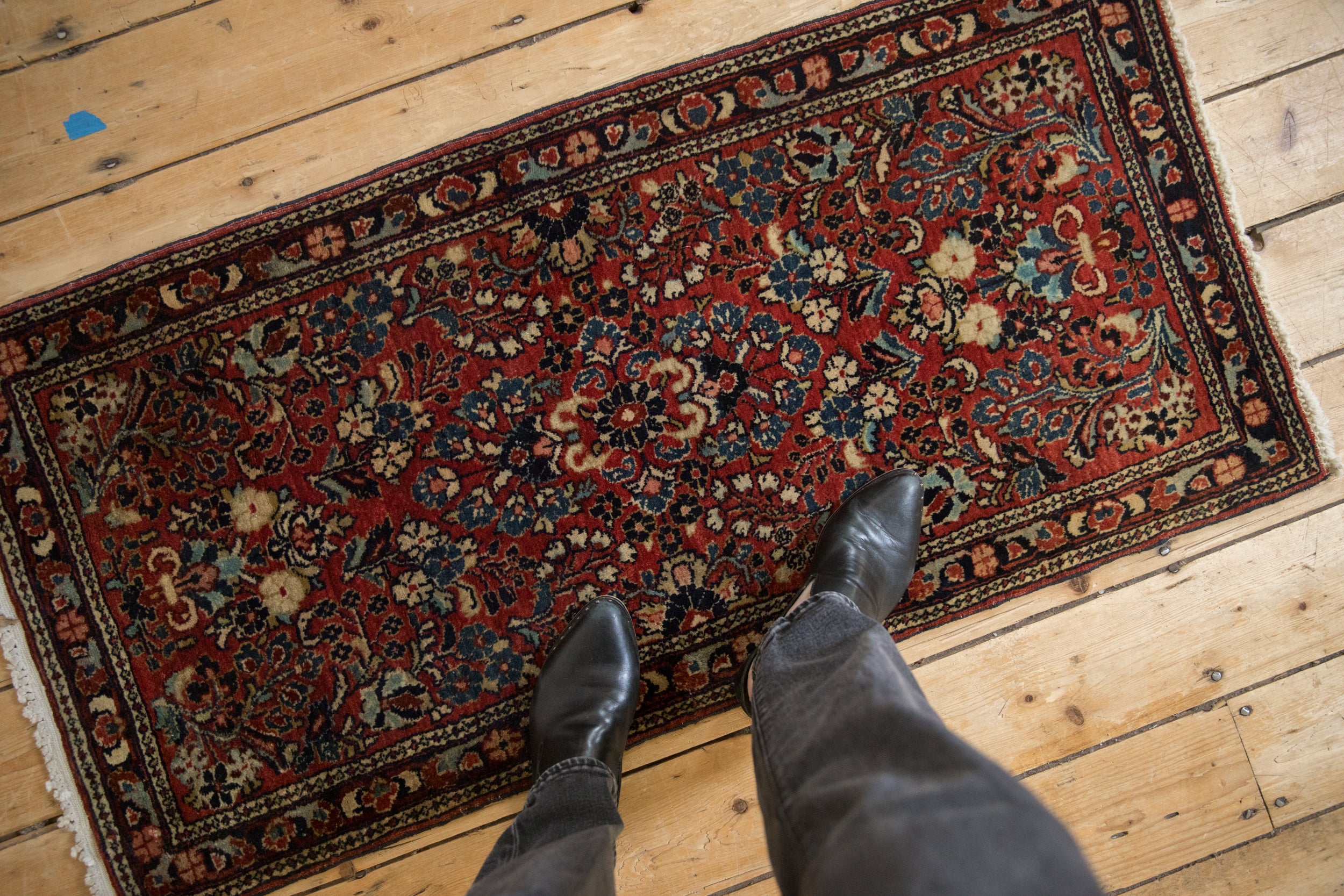 Hand-knotted vintage German Sarouk rug runner, red field, blue floral sprays underfoot.