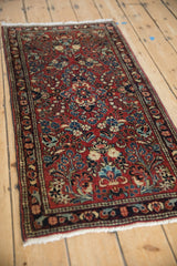 Intricate red field with sapphire blue, ivory, and powder blue floral motifs on vintage Sarouk rug.