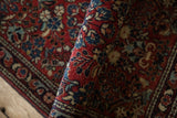 Detailed hand-knotted pile of a vintage German Sarouk rug with red and blue flowers.