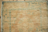 Distressed soft beige woolen pile and faded blue border with intact selvage.