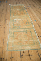 Antique distressed Peking runner, visible repeating panels, faded beige and powder blue.