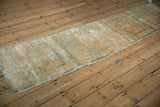 Storied texture and faded beige, powder blue motifs of an antique Peking runner.