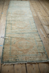 Worn low pile and short, delicate fringe detail on the end of the Peking rug.