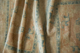 Luminous distressed pile showing knot heads, soft beige, and blue Peking runner patterns.
