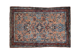 Dusty copper vintage Persian Mehreban rug, central floral pinwheel medallion, with blue and burgundy motifs.