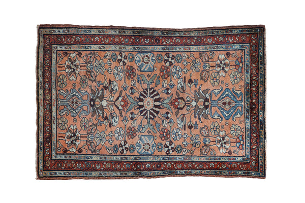 Dusty copper vintage Persian Mehreban rug, central floral pinwheel medallion, with blue and burgundy motifs.