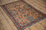 Vintage Mehreban rug corner showing dark burgundy floral border and dusty copper field.