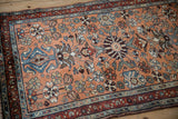 Dusty copper Persian Mehreban rug detail: denim blue serpent border, intricate floral field, and main border.