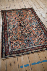 Vintage Persian Mehreban rug's dusty copper floral blossom field and serpent inner border.