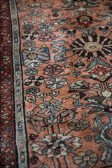 Vintage Mehreban rug detail with dusty copper floral field, serrated leaves, and burgundy border.